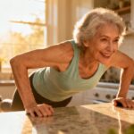 Elderly woman doing push-ups in her kitchen, demonstrating daily stretching and fitness routine for seniors, promoting health, flexibility, and active aging.
