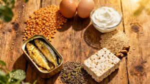 1. Canned sardines, eggs, lentils, quinoa, seeds, nuts, and dairy on rustic wooden table for high-protein, healthy eating, and nutrition.